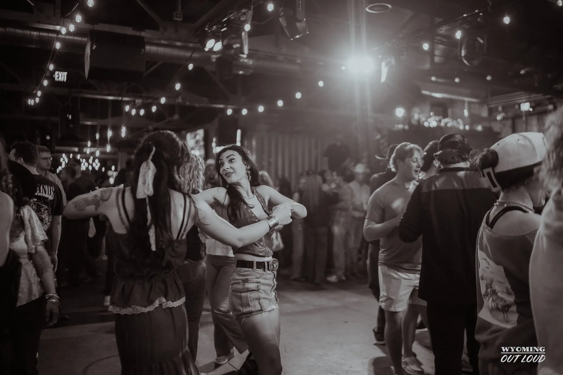Friends dancing under the lights at The Gaslight Social